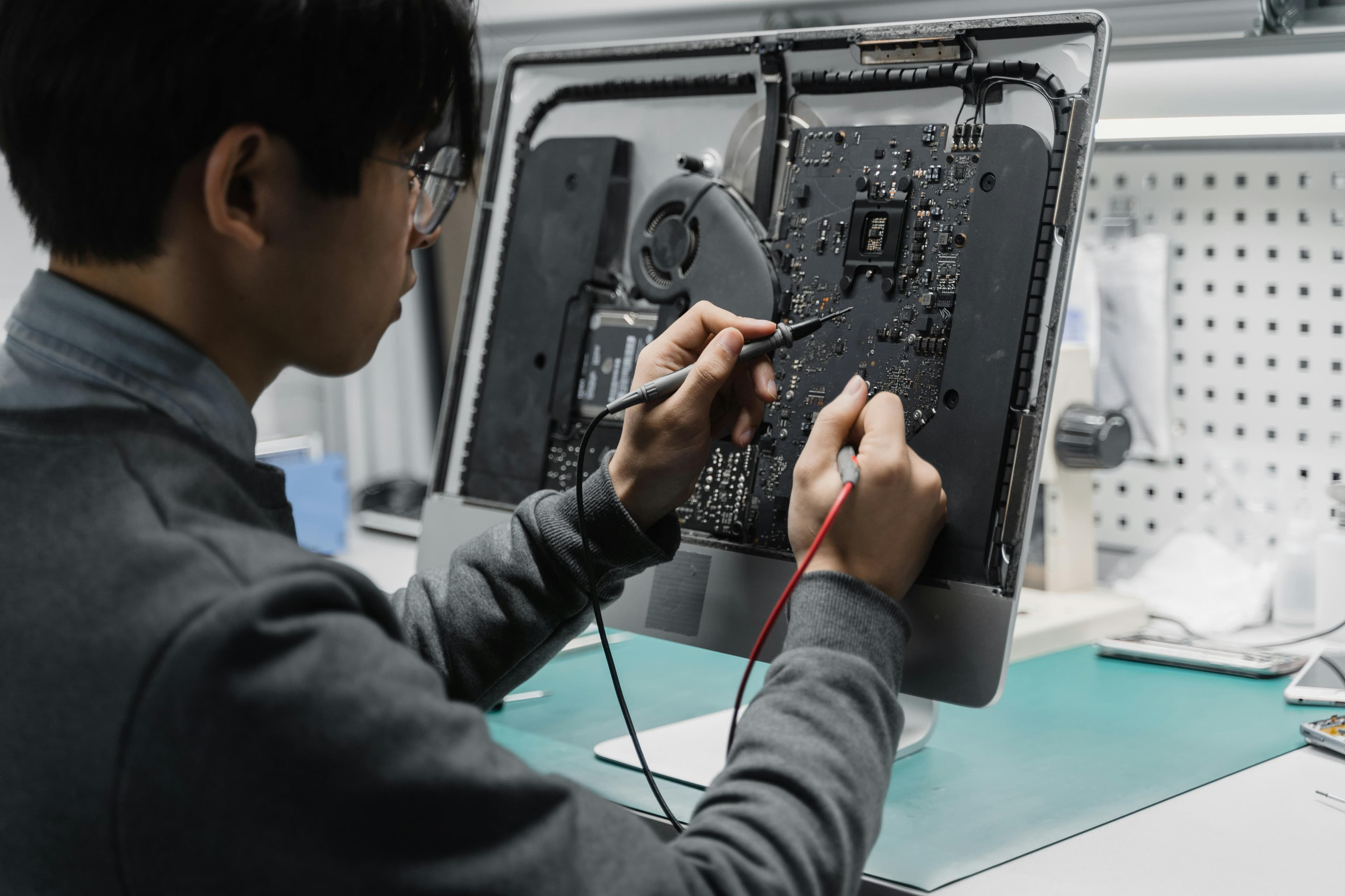 Technician repairing a computer in a clean workspace